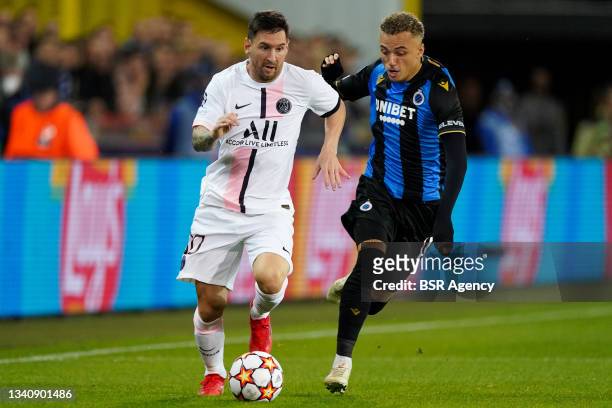 Lionel Messi of Paris Saint-Germain runs with the ball under pressure of Noa Lang of Club Brugge during the UEFA Champions League Group Stage match...