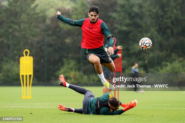 Jose Sa of Wolverhampton Wanderers saves the ball from Francisco Trincao during a Wolverhampton Wanderers Training Session at Sir Jack Hayward...