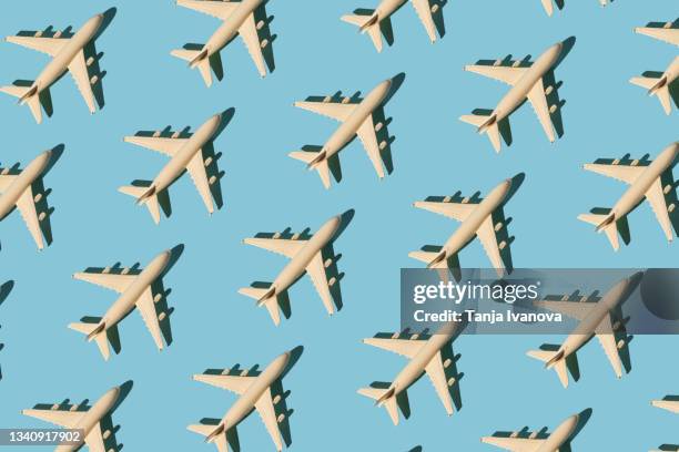 seamless pattern with toy airplane on blue background. creative travel concept - toy airplane stock-fotos und bilder