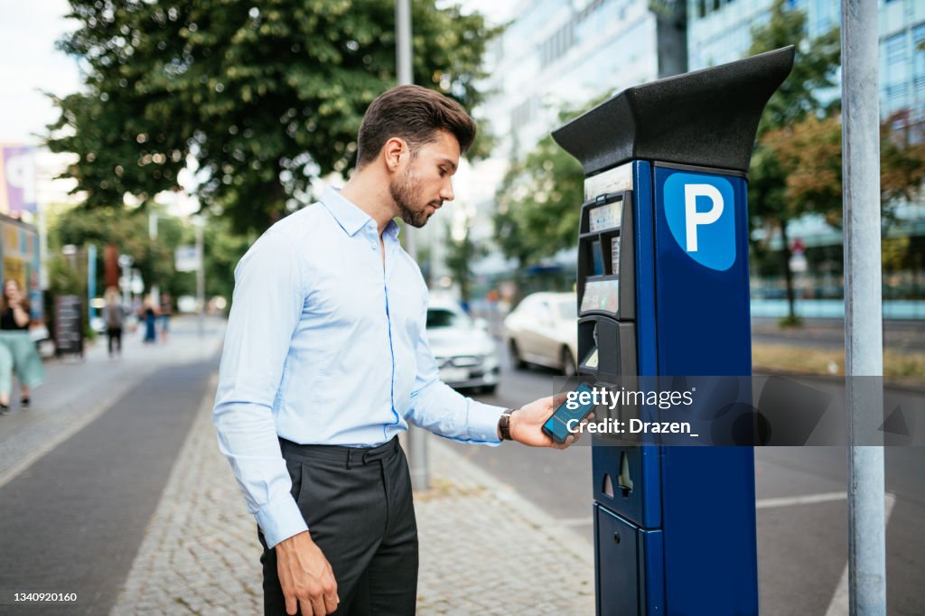 Business person paying parking in the city