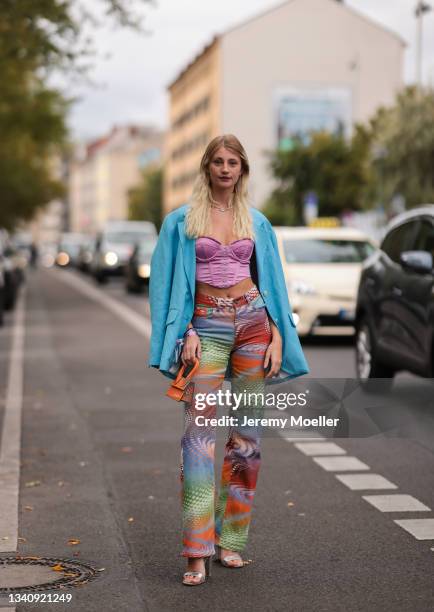 Trixie Giese wearinv a blue blazer, pink top, Jacquemus bag and colorful pants on September 13, 2021 in Berlin, Germany.