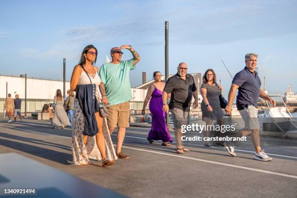 couple walking at the harbor promenade - ponta delgada stock pictures, royalty-free photos & images