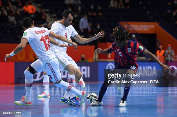 Tomas Pondeca of USA battles for possession with Farhad Tavakoli and Ahmad Esmaeilpour of IR Iran during the FIFA Futsal World Cup 2021 group F match...