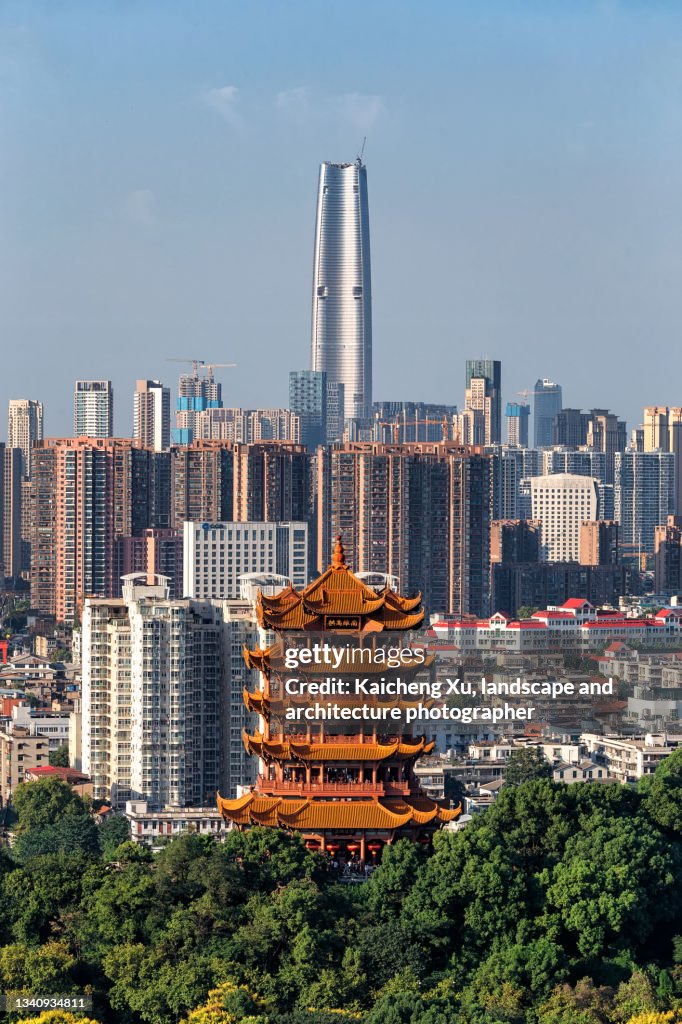 Yellow crane tower with Lvdi Center behind