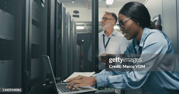 shot of a man and woman working together in a data centre - online database stock pictures, royalty-free photos & images