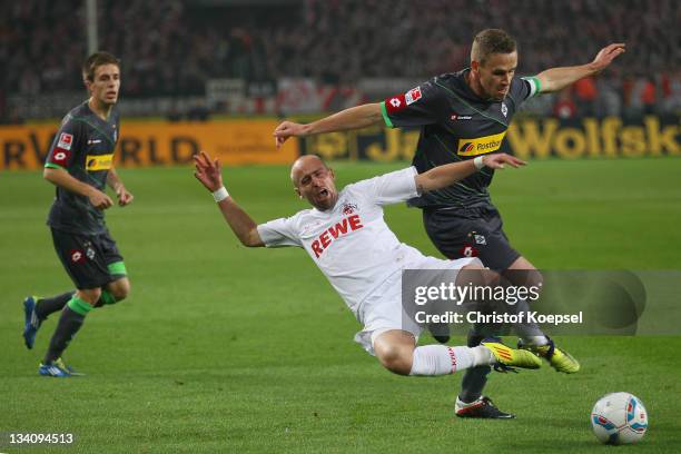 Filip Daems of Moenchengladbach challenges Miso Brecko of Koeln during the Bundesliga match between 1. FC Koeln and Borussia Moenchengladbach at...