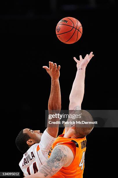 Victor Davila of the Virginia Tech Hokies and Philip Jurick of the Oklahoma State Cowboys battle for the ball during a game at the 2011 Dick's...