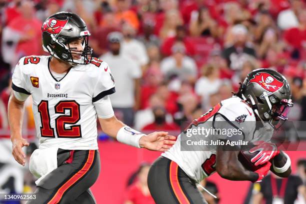 Tom Brady hands the ball off to Ronald Jones of the Tampa Bay Buccaneers during the first half at Raymond James Stadium on September 09, 2021 in...