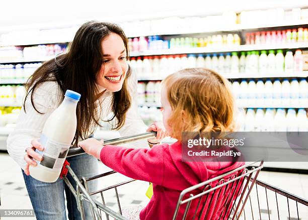 glückliche mutter und tochter-shopping - mom buying milk stock-fotos und bilder