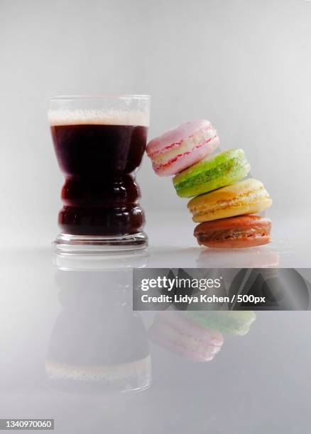 close-up of macaroons by coffee cup on white background - macaron photos et images de collection