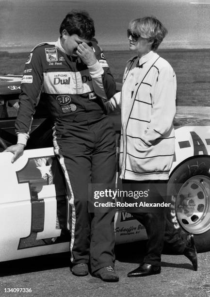 Driver Dale Jarrett stands beside his race car with his wife, Kelley, at the Daytona International Speedway just prior to the start of the 1988...