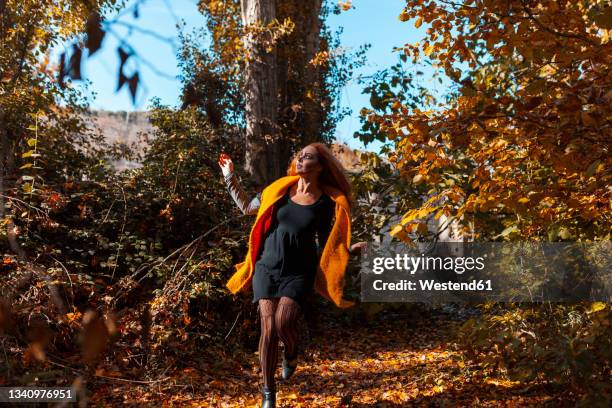 woman with spooky make-up running in forest during halloween - running fancy dress stock-fotos und bilder