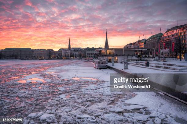 germany, hamburg, frozen inner alster lake at winter dawn - alster hamburg stock pictures, royalty-free photos & images