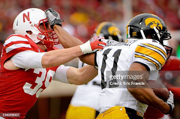 Wide receiver Kevonte Martin-Manley of the Iowa Hawkeyes tries to shake safety Justin Blatchford of the Nebraska Cornhuskers during their game at...