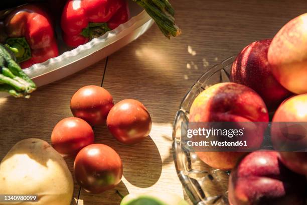 fresh fruits and vegetables on table at kitchen - fruit bowl stock pictures, royalty-free photos & images