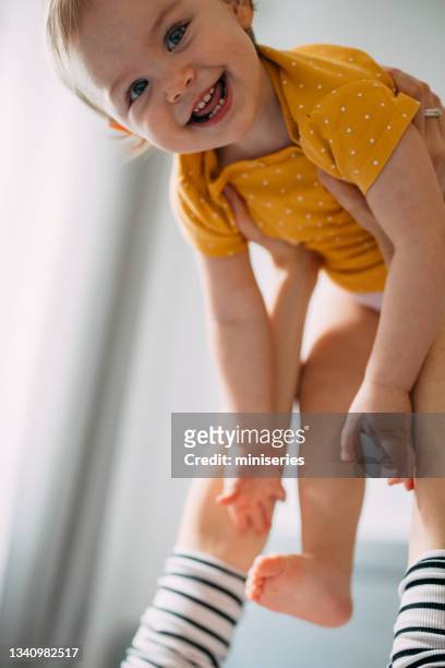 unrecognizable mother and her daughter having fun in bedroom - beautiful blonde babes stock pictures, royalty-free photos & images