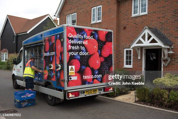 Tesco grocery home delivery van and person, deliver groceries to a home on August 20, 2021 in Chelmsford, England.