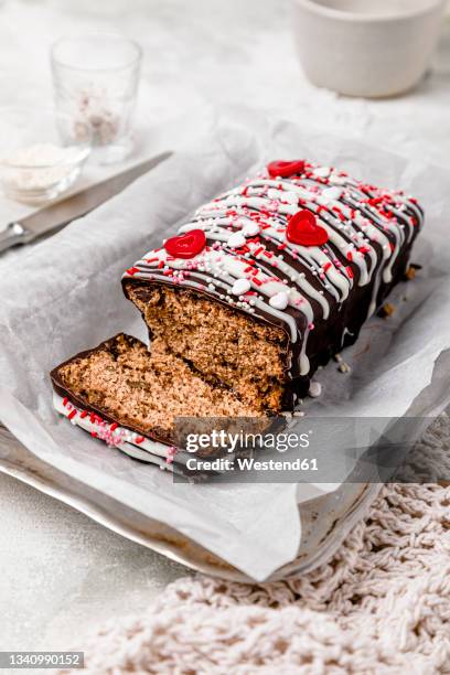 glazed chocolate cake with sugar sprinkles and heart shaped decorations - glazed food stock pictures, royalty-free photos & images