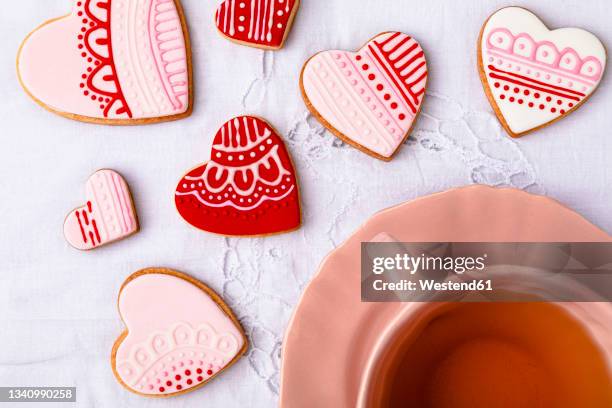 studio shot of cup of tea and heart shaped cookies - cookie studio stock pictures, royalty-free photos & images