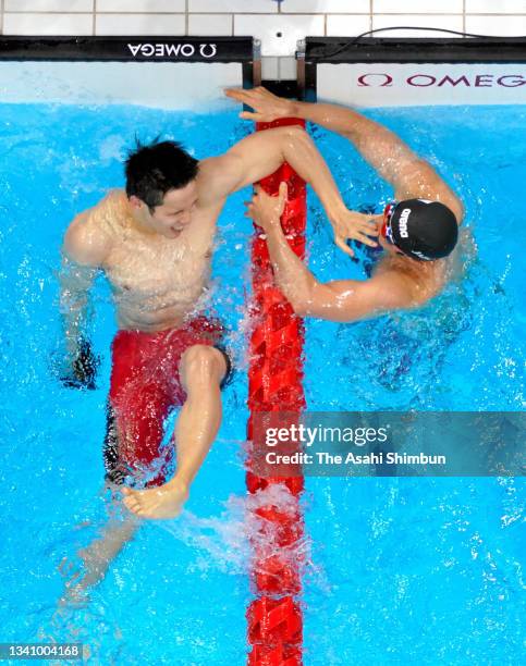 Keiichi Kimura and Uchu Tomota of Team Japan celebrate winning the gold and silver respectively after competing in the Swimming Men's 100m Butterfly...