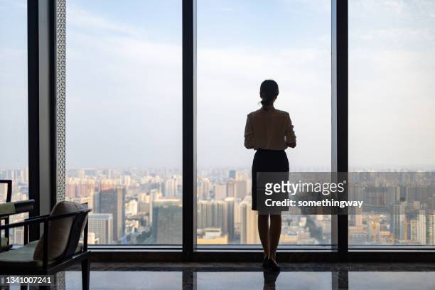 business women in front of glass windows - in front of stockfoto's en -beelden