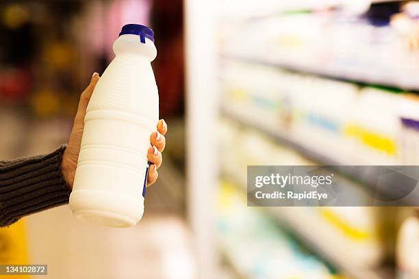 milk bottle in supermarket - milk bottle stock pictures, royalty-free photos & images