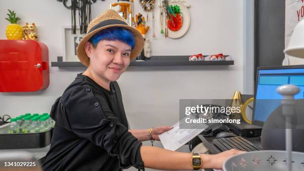 professional woman looking at the camera smiling - file clerk stock pictures, royalty-free photos & images