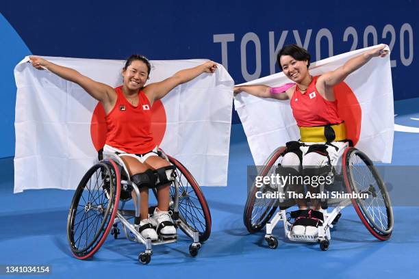 Yui Kamiji and Momoko Otani of Team Japan celebrate winning the bronze medal after their victory in the Wheelchair Tennis Women's Doubles Bronze...