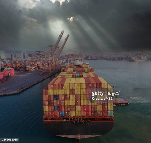 loaded cargo container ship leaving port after a rainy day. - crushed leaves stock pictures, royalty-free photos & images