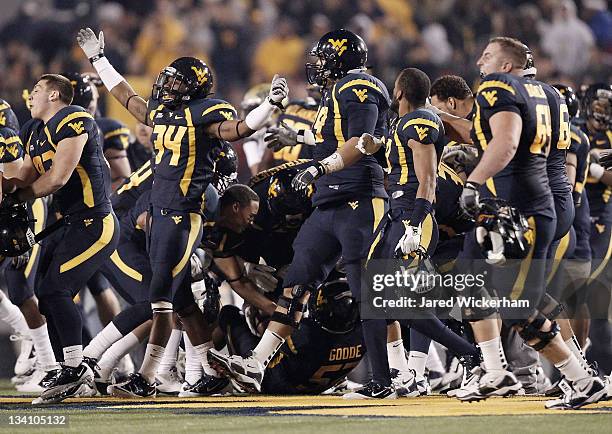 Ishmael Banks of the West Virginia Mountaineers celebrates with his teammates following their win against the University of Pittsburgh Panthers...