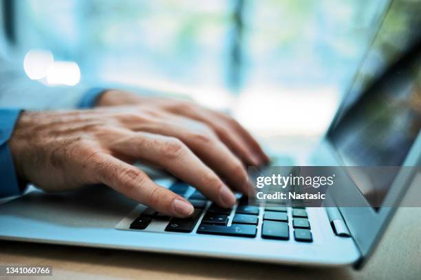 business hands typing on a laptop - close up computer mouse imagens e fotografias de stock