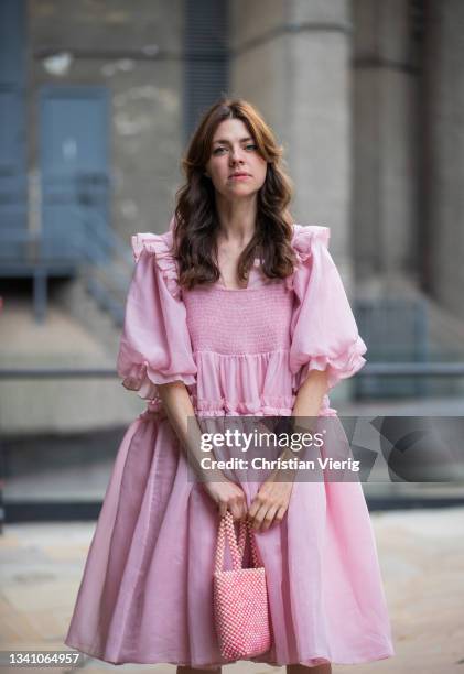 Guest is seen wearing pink dress and bag outside Rixo during London Fashion Week September 2021 on September 17, 2021 in London, England.