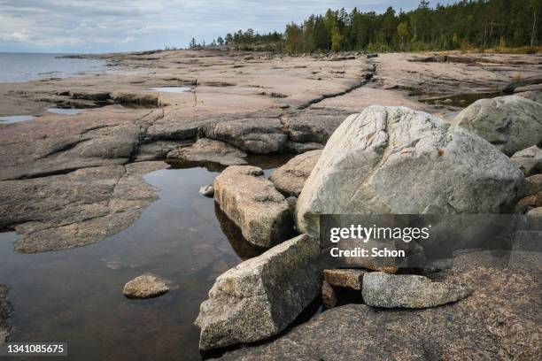 rock formations by the sea in rotsidan nature reserve in the high coast in daylight - höga kusten bildbanksfoton och bilder