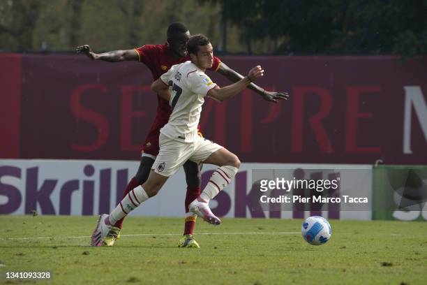 Leonardo Rossi of AC Milan U19 competes for the ball with Codou Maissa Ndiaye of AS Roma during the Primavera 1 match between AC Milan U19 and AS...