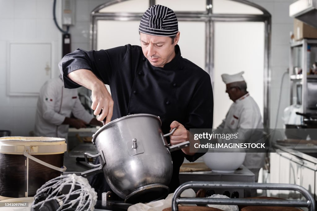 Master baker preparing custard in the industrial mixer