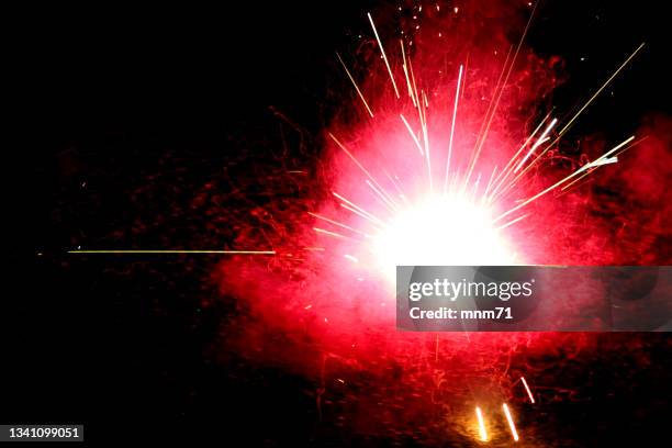 ground spinner firework in the street - firework explosive material stock pictures, royalty-free photos & images