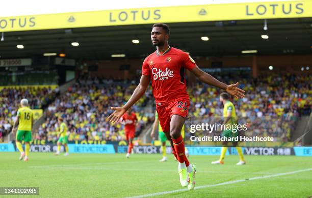 Emmanuel Dennis of Watford FC celebrates after scoring their team's first goal during the Premier League match between Norwich City and Watford at...