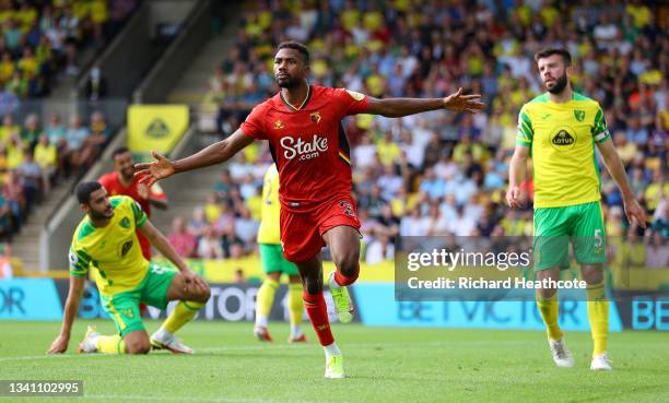 Emmanuel Dennis of Watford FC celebrates after scoring their team's first goal during the Premier League match between Norwich City and Watford at...
