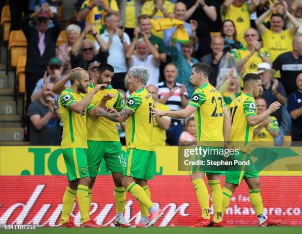 Teemu Pukki of Norwich City celebrates with teammate Mathias Normann and Ozan Kabak after scoring their side's first goal during the Premier League...