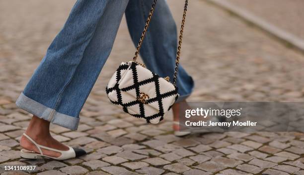 Jill Asemota wearing Chanel black and white bag, Khaite blue jeans and Chanel shoes on September 13, 2021 in Berlin, Germany.