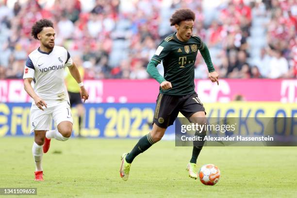 Leroy Sane of FC Bayern Muenchen fights for the ball with Herbert Bockhorn of VfL Bochum during the Bundesliga match between FC Bayern München and...