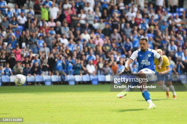 Jonson Clarke-Harris of Peterborough United scores a penalty for his team's second goal during the Sky Bet Championship match between Peterborough...