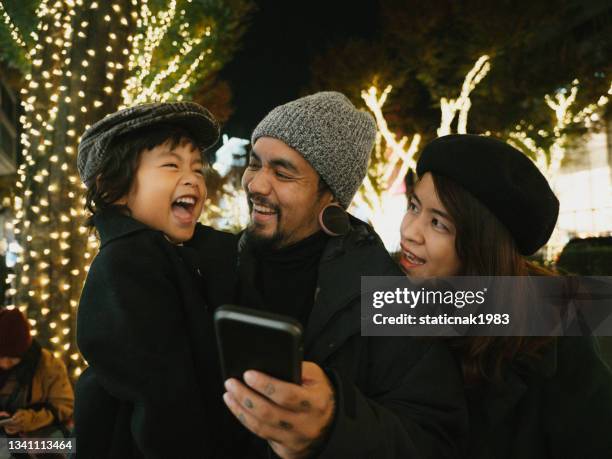 happy family having fun in the city during holidays. - happy holidays family stock pictures, royalty-free photos & images