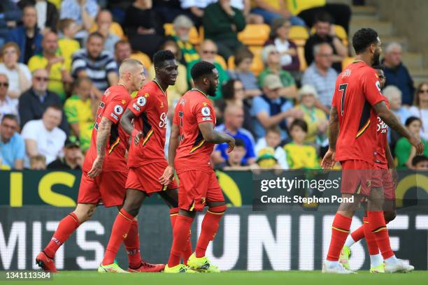 Ismaila Sarr of Watford FC celebrates with teammates after scoring their team's second goal during the Premier League match between Norwich City and...