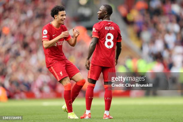 Naby Keita of Liverpool celebrates with teammate Curtis Jones after scoring their team's third goal during the Premier League match between Liverpool...