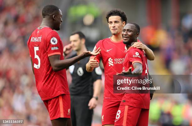 Naby Keita of Liverpool celebrates with teammates Curtis Jones and Ibrahima Konate after scoring their team's third goal during the Premier League...