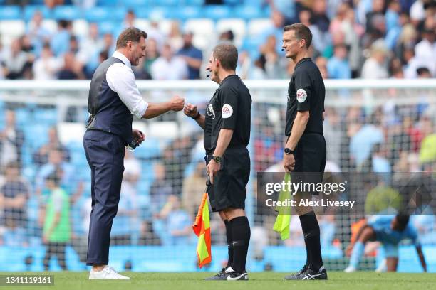 Ralph Hasenhuettl, Manager of Southampton interacts with referee, Jonathan Moss following the Premier League match between Manchester City and...