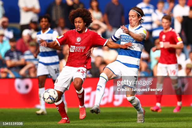 Han-Noah Massengo of Bristol City is put under pressure by Stefan Johansen of Queens Park Rangers during the Sky Bet Championship match between...