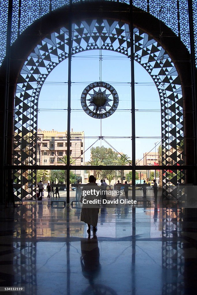 Woman walking through Muslim crystal arch