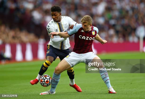 Matt Target of Aston Villa tackles Demarai Gray of Everton during the Premier League match between Aston Villa and Everton at Villa Park on September...